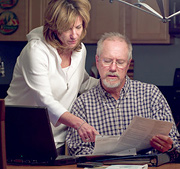 An older couple going over their banking information. - Copyright – Stock Photo / Register Mark