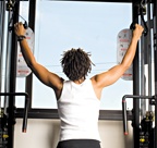 Chelsea Cooper demonstrates a kneeling cable pulldown. - Copyright – Stock Photo / Register Mark