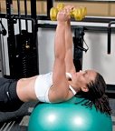 Chelsea Cooper demonstrates a tricep exercise using a stability ball. - Copyright – Stock Photo / Register Mark