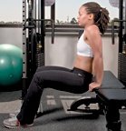 Chelsea Cooper demonstrates a tricep bench dip. - Copyright – Stock Photo / Register Mark