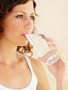Woman drinking a glass of water. - Copyright – Stock Photo / Register Mark