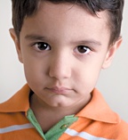 The face of a depressed little boy. - Copyright – Stock Photo / Register Mark