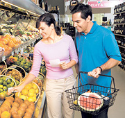 A middle aged couple shopping in the produce aisle. - Copyright – Stock Photo / Register Mark