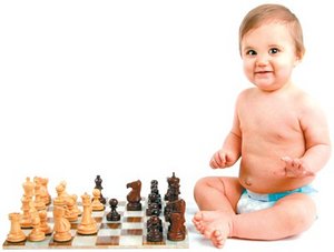 Baby sitting next to a chess set. - Copyright – Stock Photo / Register Mark