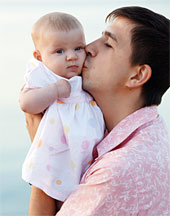 Father kissing baby - Copyright – Stock Photo / Register Mark