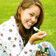 Young woman eating yogurt. - Copyright – Stock Photo / Register Mark
