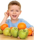 Young boy with various fruits in front of him. - Copyright – Stock Photo / Register Mark