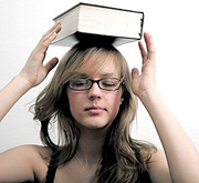 Young woman balancing large book on top of her head. - Copyright – Stock Photo / Register Mark