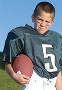 A young boy in his football gear. - Copyright – Stock Photo / Register Mark