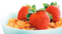 A healthy bowl of corn flakes and strawberries. - Copyright – Stock Photo / Register Mark