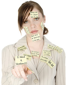 A stressed out office worker covered in post it notes. - Copyright – Stock Photo / Register Mark