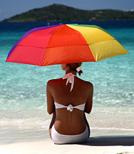 Lady under beach umbrella - Copyright – Stock Photo / Register Mark
