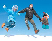 Family of three jumping over a ridge of snow. - Copyright – Stock Photo / Register Mark