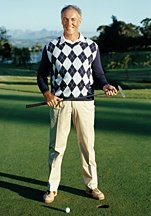 Male golfer standing and holding putter. - Copyright – Stock Photo / Register Mark