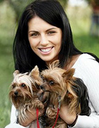 A woman holding two small terriers. - Copyright – Stock Photo / Register Mark