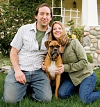 A couple pose with their boxer. - Copyright – Stock Photo / Register Mark