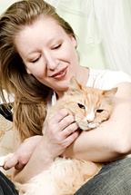 A woman hugs and pets her cat. - Copyright – Stock Photo / Register Mark