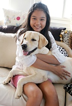 A young girl hugs her golden rectriever to her. - Copyright – Stock Photo / Register Mark