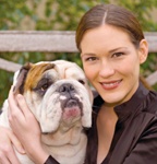 A woman poses with her bulldog. - Copyright – Stock Photo / Register Mark