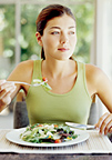 Woman eating a healthy salad. - Copyright – Stock Photo / Register Mark