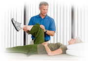 A chiropractor examines a middle aged woman's leg. - Copyright – Stock Photo / Register Mark