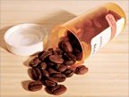 Tipped perscription pill bottle that has coffee beans spilling out. - Copyright – Stock Photo / Register Mark
