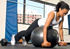 Chelsea Cooper demonstrates a ball dumbbell row. - Copyright – Stock Photo / Register Mark