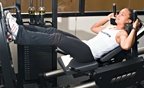 Chelsea Cooper demonstrates the leg press. - Copyright – Stock Photo / Register Mark