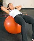 Chelsea Cooper demonstrating a Ball Crunch. - Copyright – Stock Photo / Register Mark