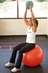 Chelsea Cooper demonstrating Long-Lever Ball Crunch with Medicine Ball. - Copyright – Stock Photo / Register Mark