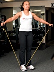 Chelsea Cooper demonstrates a rubber-band side raise. - Copyright – Stock Photo / Register Mark