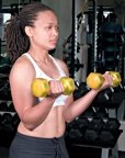 Chelsea Cooper demonstrates a proper dumbbell curl. - Copyright – Stock Photo / Register Mark