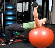 Chelsea Cooper performing stability ball barbell press. - Copyright – Stock Photo / Register Mark