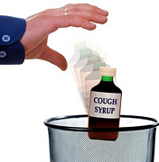 A Hand throwing a bottle of cough syrup into garbage can. - Copyright – Stock Photo / Register Mark