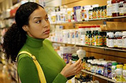 Woman shopping for supplements. - Copyright – Stock Photo / Register Mark