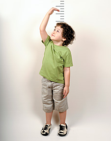 kid measuring height - Copyright – Stock Photo / Register Mark