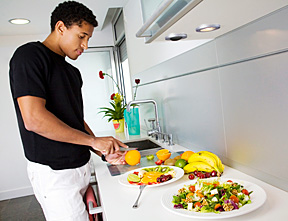man preparing food in kitchen - Copyright – Stock Photo / Register Mark