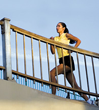 Lady running upstairs - Copyright – Stock Photo / Register Mark