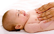 Infant enjoying a massage. - Copyright – Stock Photo / Register Mark