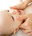 Infant having his face massaged. - Copyright – Stock Photo / Register Mark