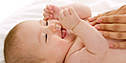 Infant enjoying a massage. - Copyright – Stock Photo / Register Mark