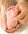 infant's foot being massaged. - Copyright – Stock Photo / Register Mark