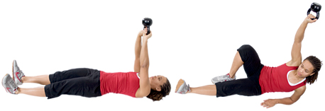  	Personal trainer Chelsea Cooper domonstrates a Turkish Get-Up with a Kettlebell. - Copyright – Stock Photo / Register Mark