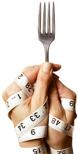Hands wrapped in a measuring tape while clutching a fork. - Copyright – Stock Photo / Register Mark