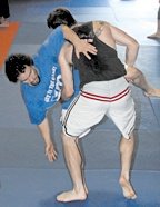 Two young fighters work on throws. - Copyright – Stock Photo / Register Mark