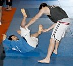 Two young fighters work on throws. - Copyright – Stock Photo / Register Mark