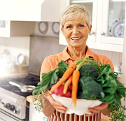 Woman holding large bowl of vegetables. - Copyright – Stock Photo / Register Mark