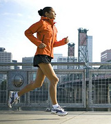 Woman jogging along the waterfront. - Copyright – Stock Photo / Register Mark