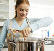 Woman stirring soup that she is cooking. - Copyright – Stock Photo / Register Mark