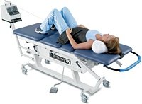 Woman on decompression table receiving therapy. - Copyright – Stock Photo / Register Mark